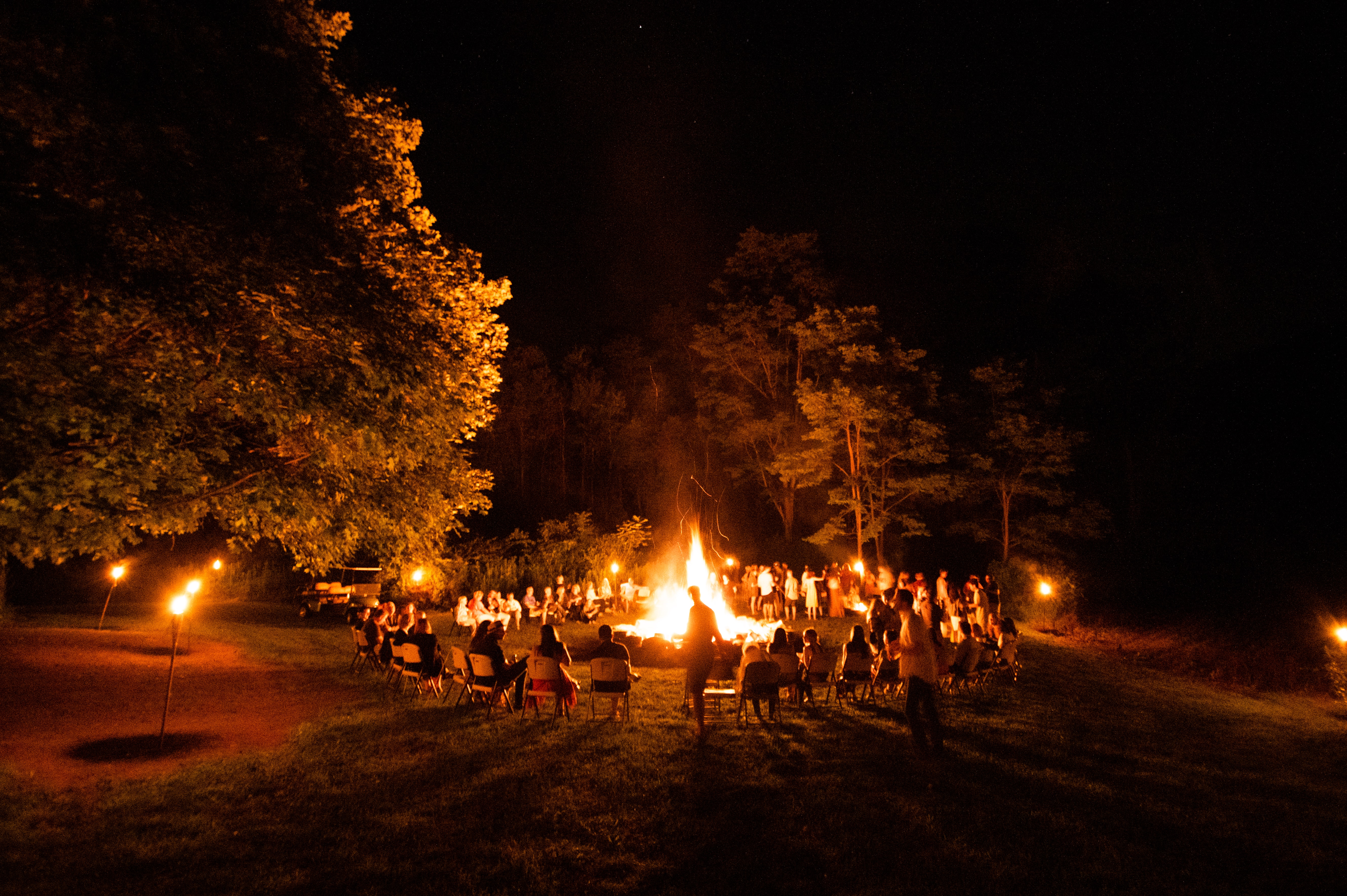 people gathering around a bonfire